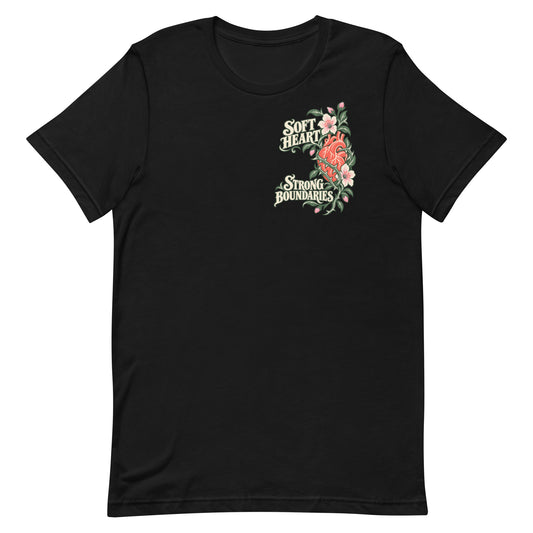 Front view of a black T-shirt with an asymmetric Soft Heart Strong Boundaries floral-heart graphic on the upper chest.