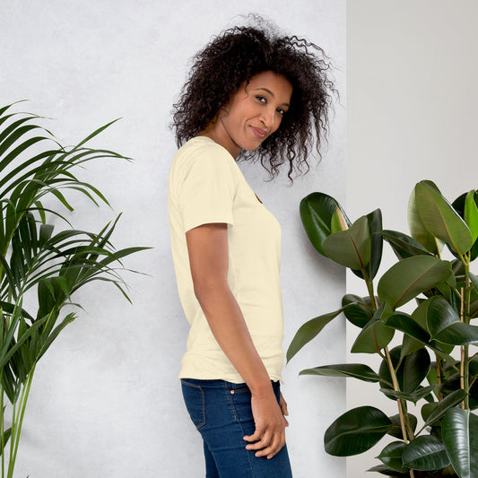 Right-side view of a curly-haired woman wearing the natural Plot Twist I Stayed Home graphic T-shirt.