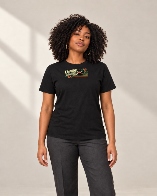 Curly-haired woman wearing the black Offline Sounds Better T-shirt with the vinyl turntable graphic across the upper chest, front view.