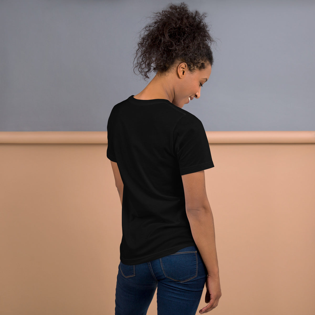 Back view of a model wearing the Mary, Joseph & Yeshua black T-shirt, showing the plain unprinted back.