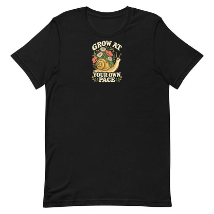 Front view of a black t-shirt with a flower-covered snail and the words Grow at Your Own Pace.