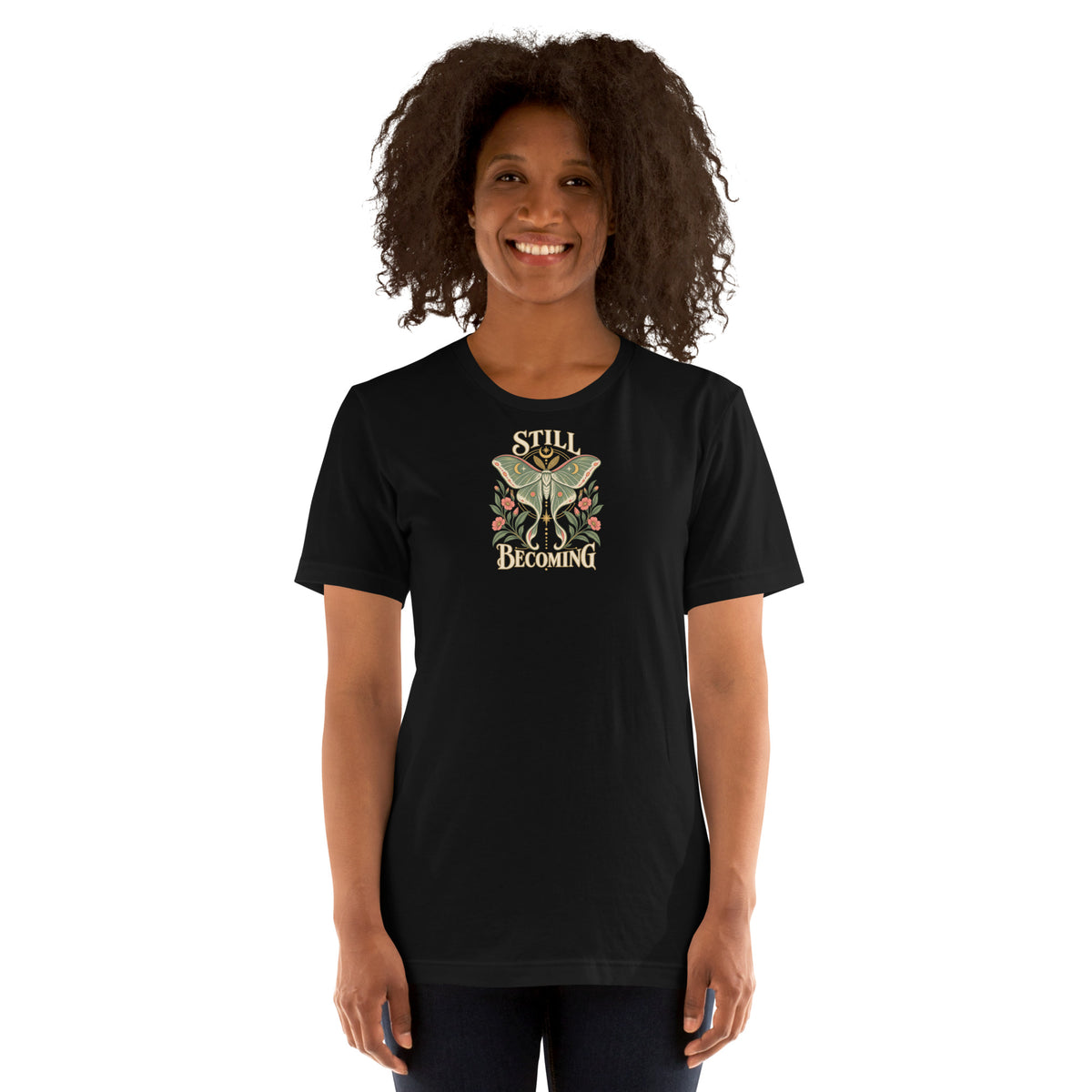 Woman wearing a black Still Becoming luna moth graphic T-shirt, shown from the front.
