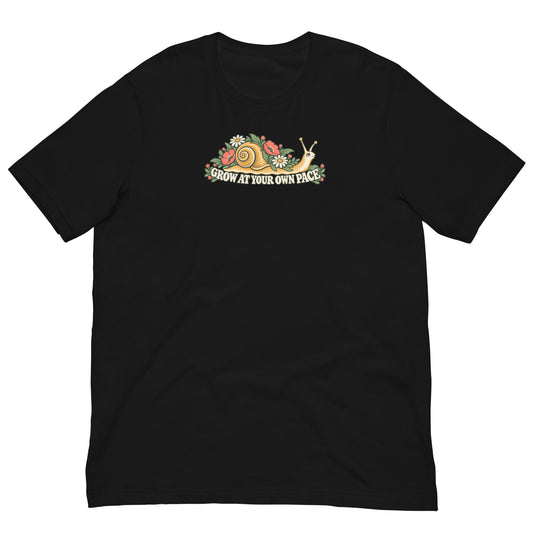 Front view of a black T-shirt with a wide Grow at Your Own Pace floral-snail graphic across the upper chest.