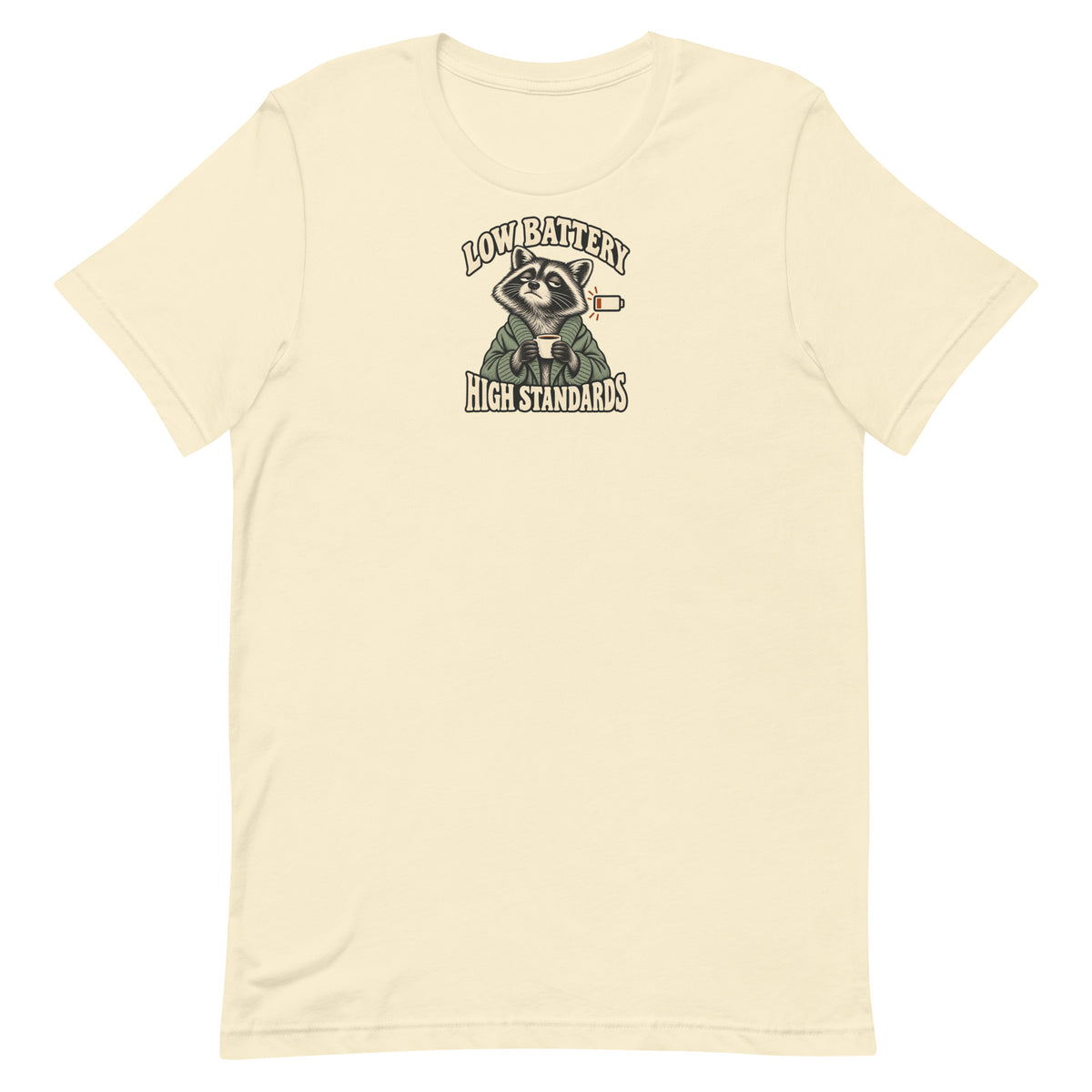 Front view of a natural-colored Low Battery High Standards t-shirt featuring a tired raccoon holding a coffee mug.