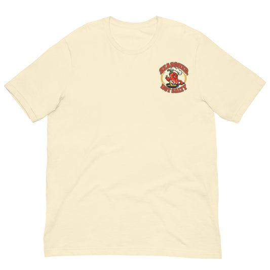 Front view of a natural-colored T-shirt with a small left-chest Seasoned, Not Salty chili-pepper chef graphic.